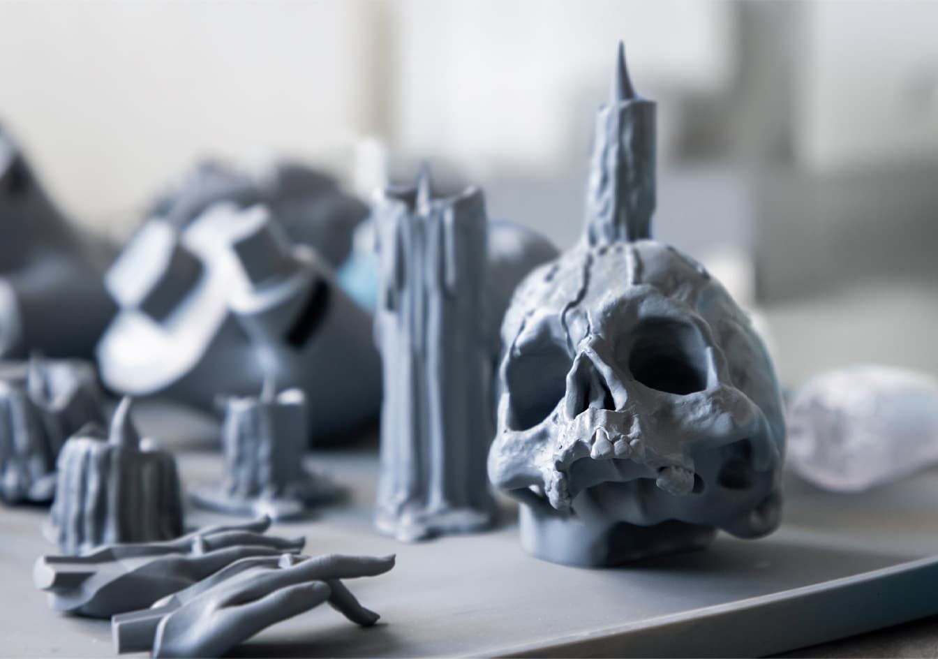 Detailed close-up on the demonic, skull-adorned base of the Morrigan statue's throne, crafted by Superkraft Lab.